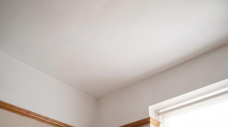 The same ceiling repaired, textured and painted with no trace of the stain