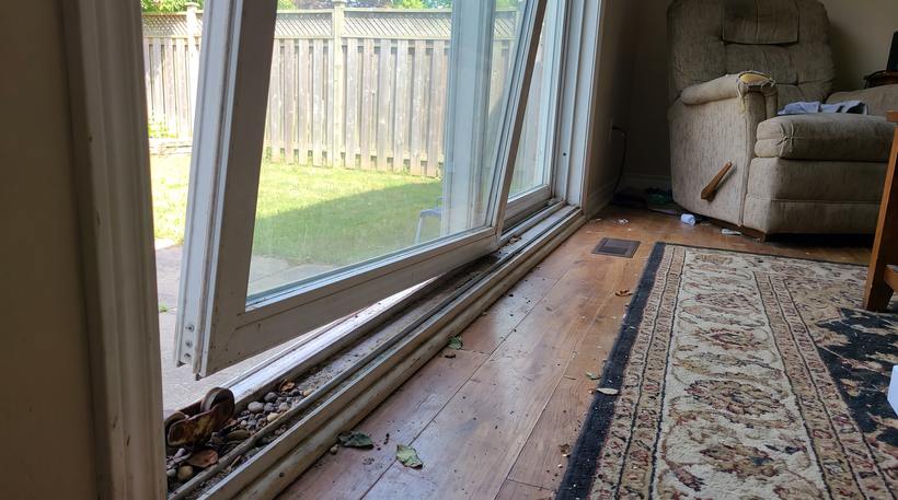 Sliding patio door stuck and grinding in a dirty, bent track