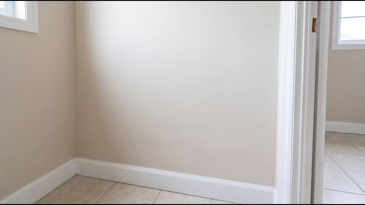 The same wall closed, textured and primed, no trace of the opening