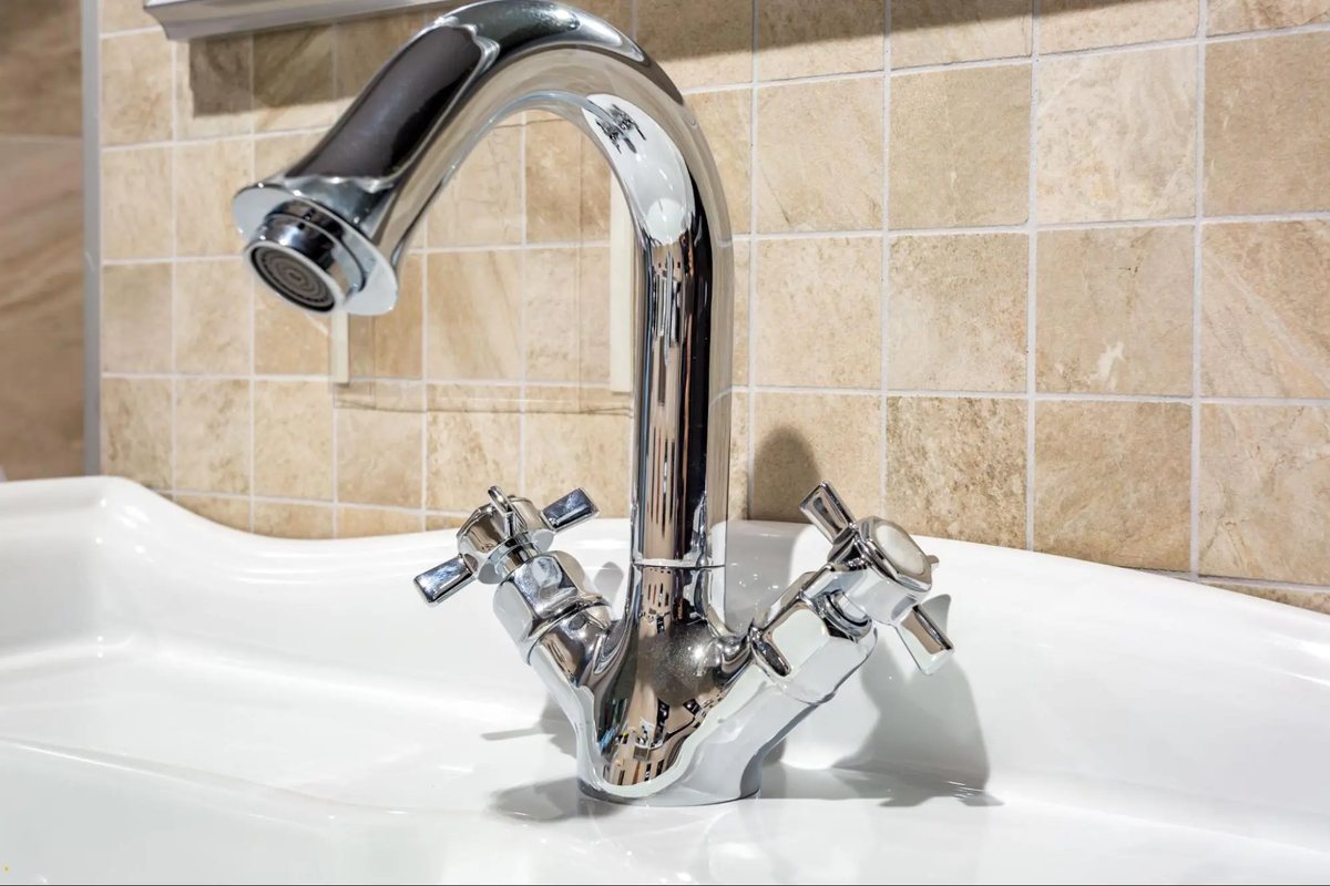 New chrome faucet installed on a bathroom sink
