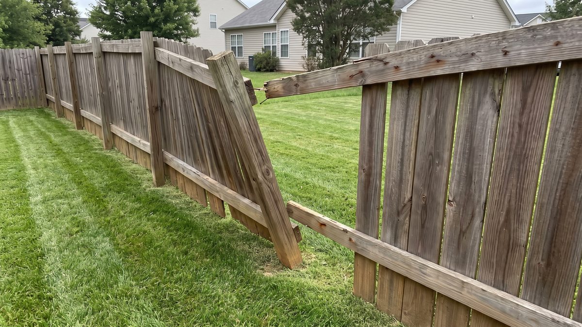 Leaning rotted fence post pulling the run out of line