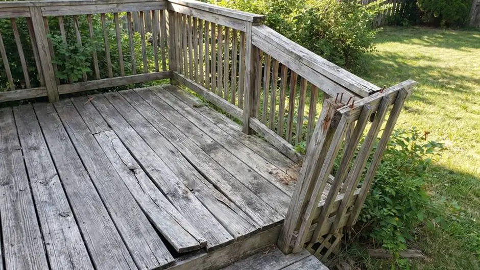 Before: split deck boards and a loose railing