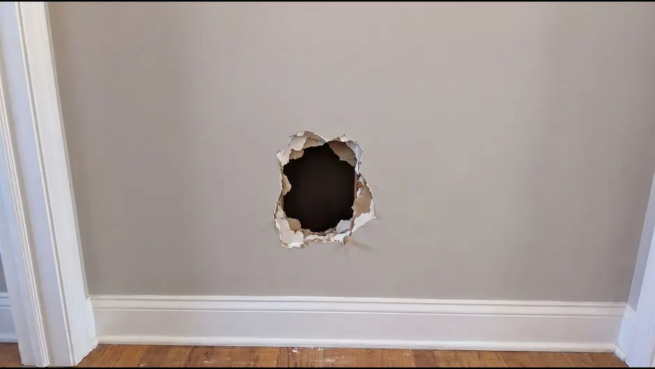 Before: a hole in a drywall wall
