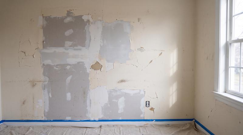 Patchy wall with peeling paint before repainting