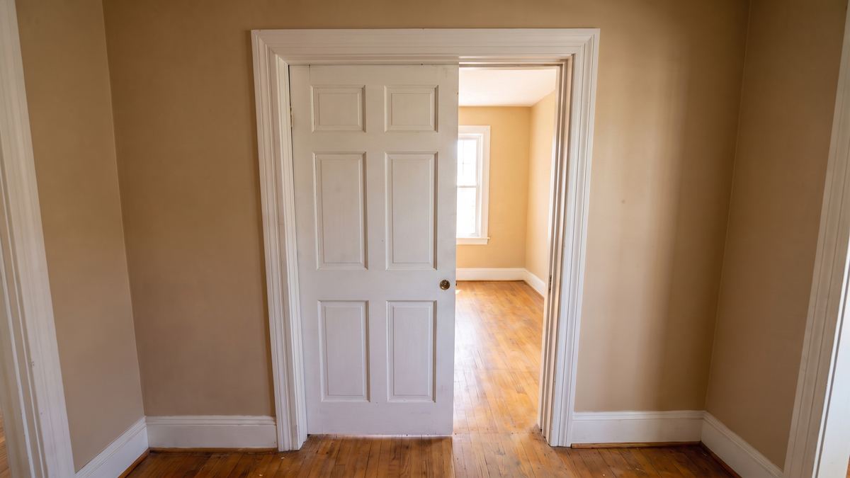 The same pocket door back on its track, hanging level and sliding half open