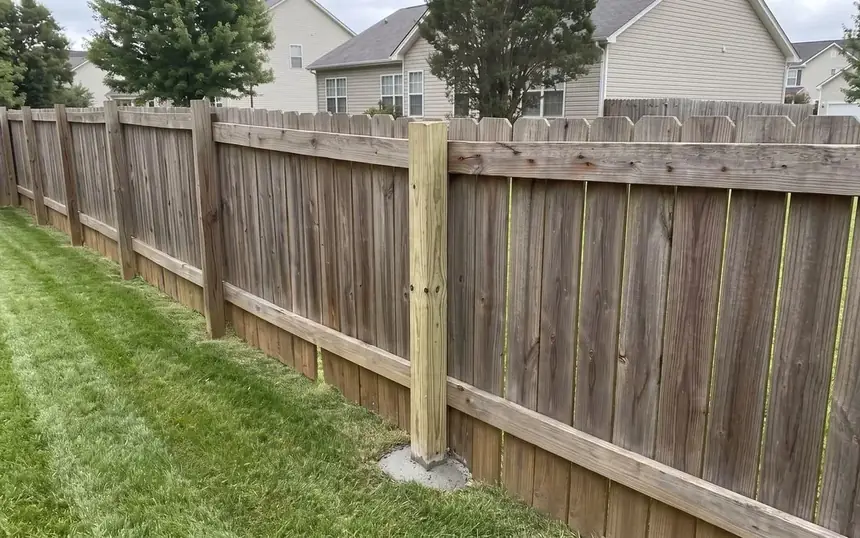 After: a new post set in concrete and the fence line straight