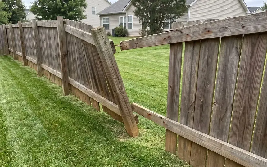 Before: a leaning fence section on a rotted post