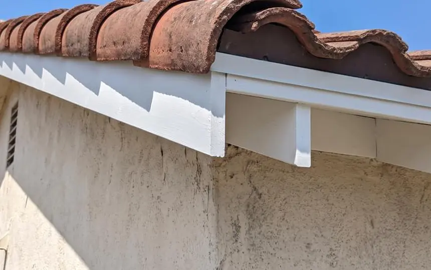 After: the eave rebuilt with new wood, primed and painted