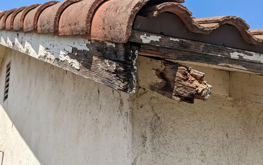 Before: rotted fascia and eave boards under a tile roof in Dallas