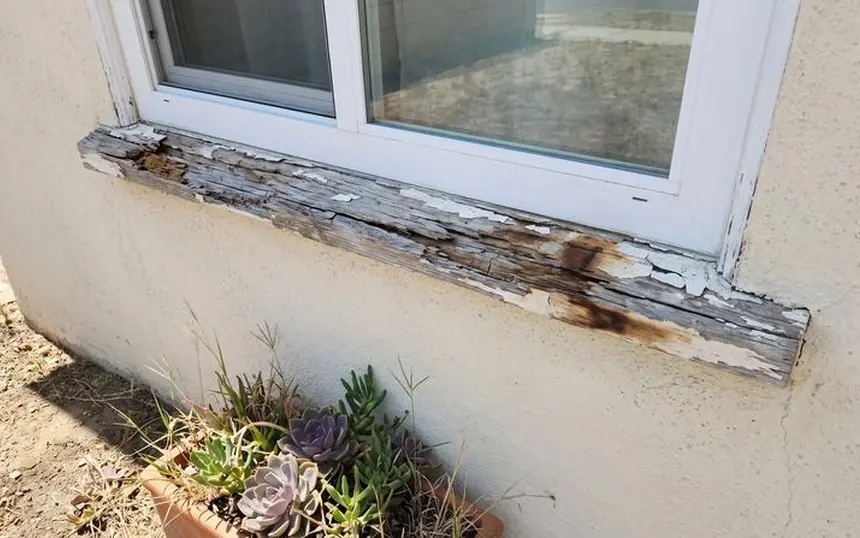 Before: a window sill rotted through at the corners