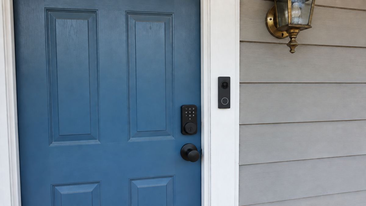 Front door with a video doorbell facing the porch and a smart deadbolt installed