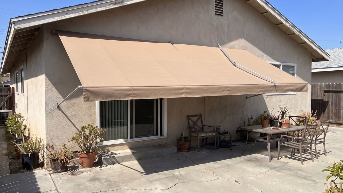 Same patio with a new tight awning installed over the sliding door