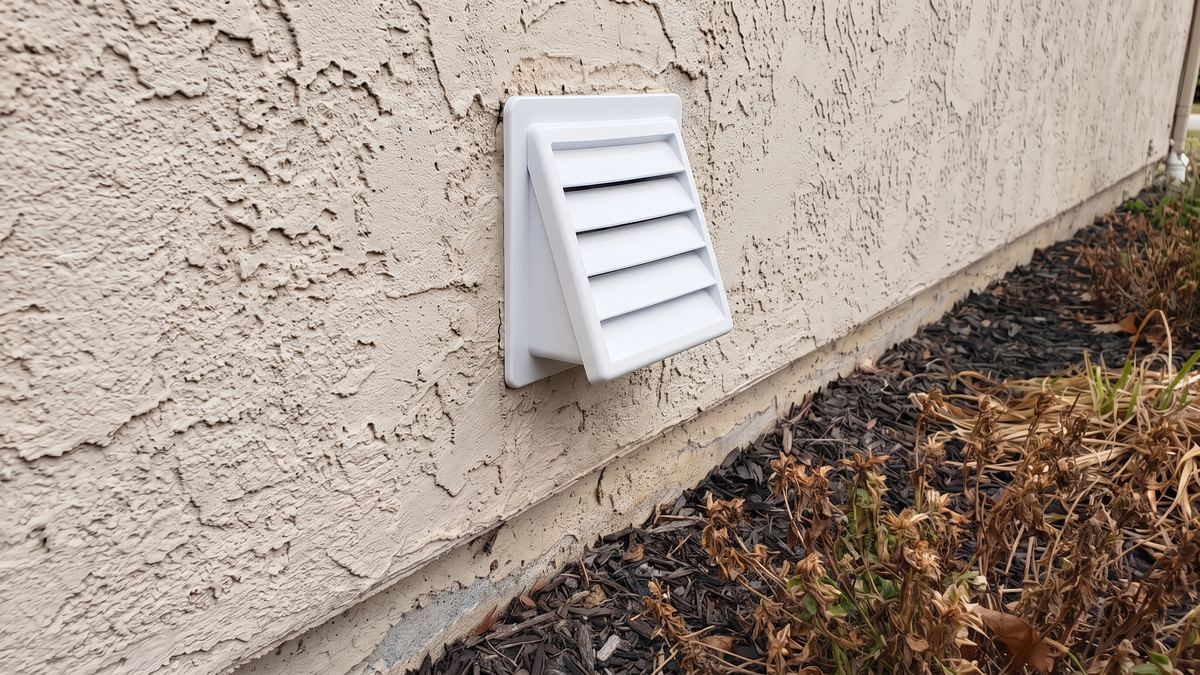 Same wall with a new clean dryer vent hood installed
