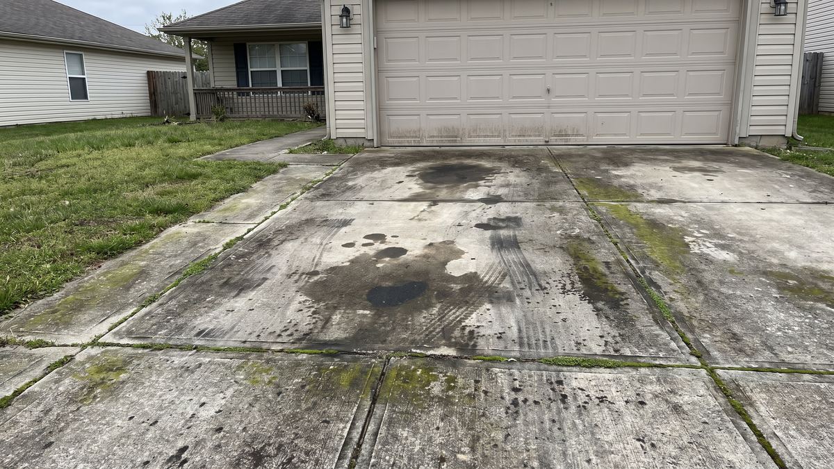 Driveway and walkway darkened with grime, oil spots and mildew