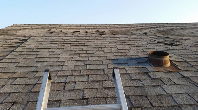 The same roof section with new matched shingles and sealed flashing