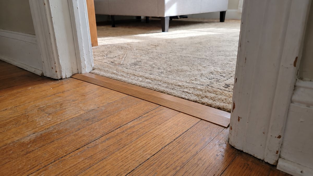 Same doorway with a low beveled transition strip instead of the raised threshold