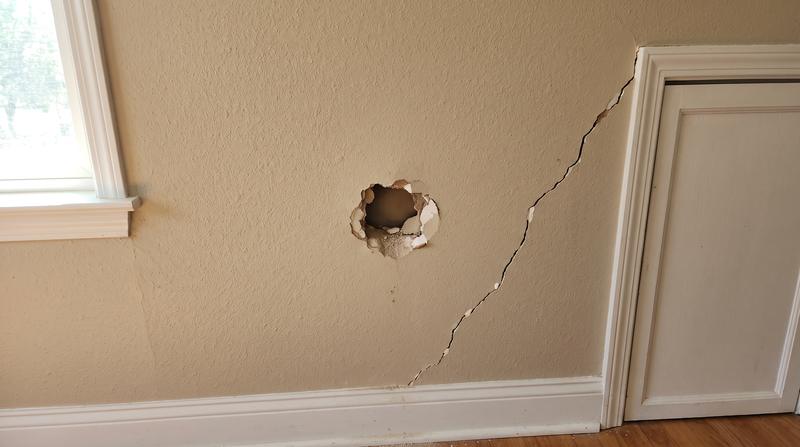Damaged drywall before repair