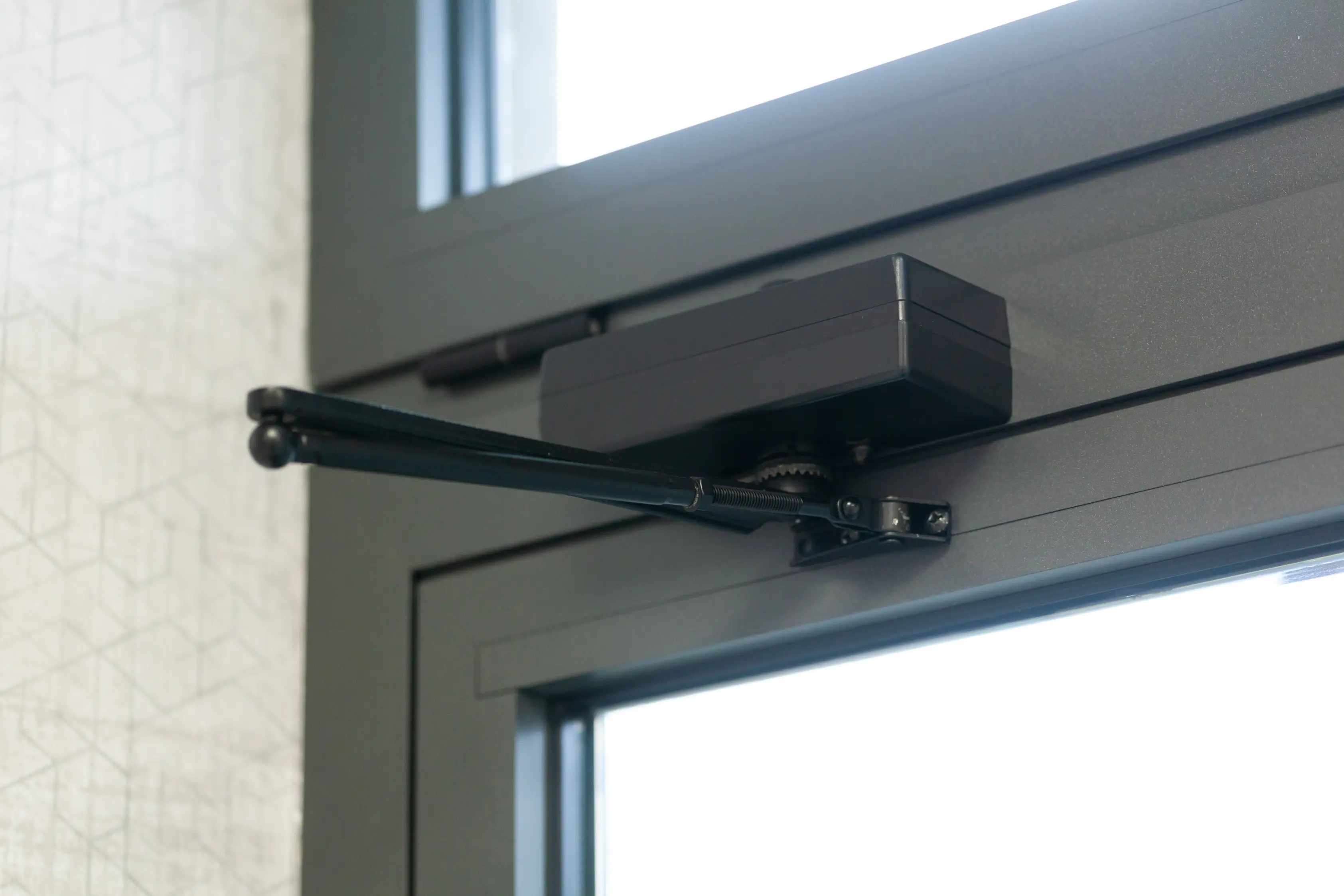 Technician installing a new door closer