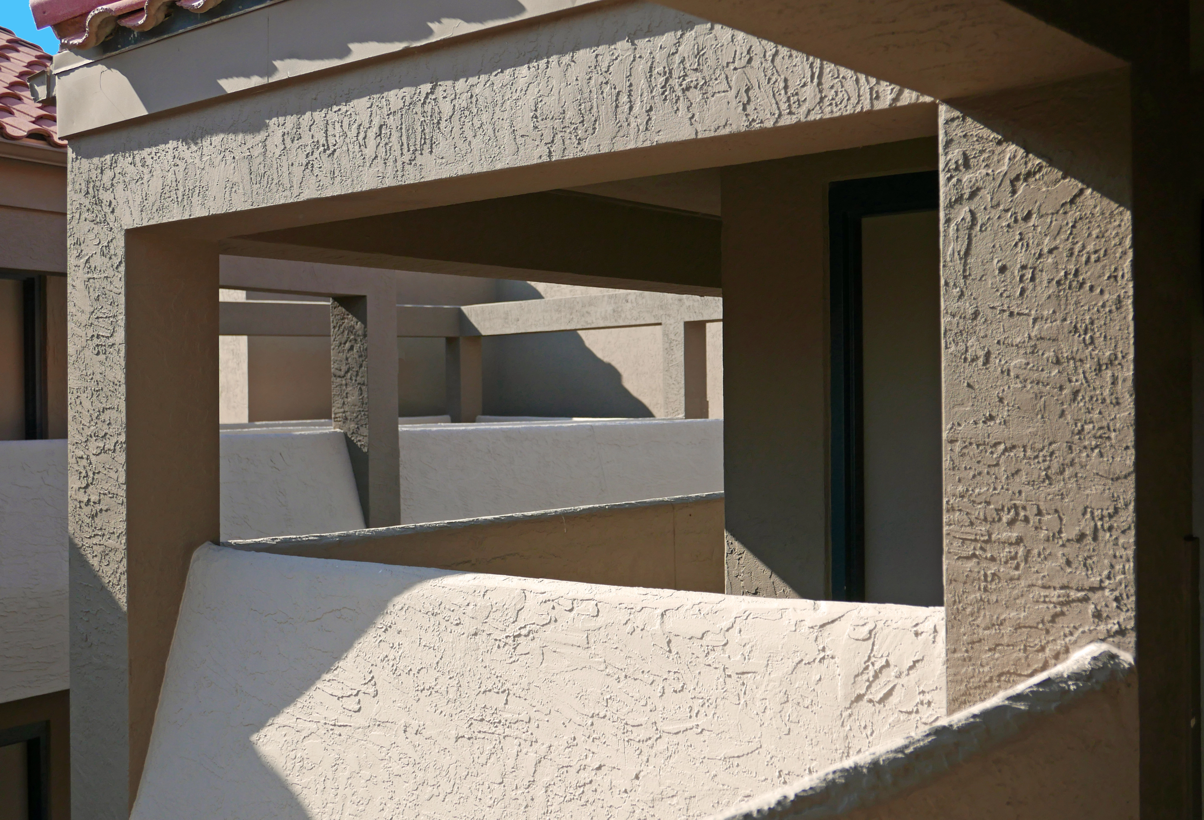 Architectural stucco detail on the breezeways of a modern building