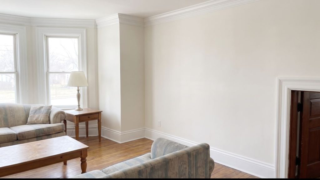 White crown molding installed along a living room ceiling